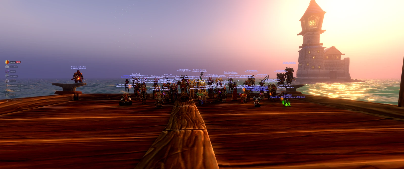 The guild gathered on the dock with the lighthouse and sunlit sea behind them; a voice-chat overlay appears at the left.